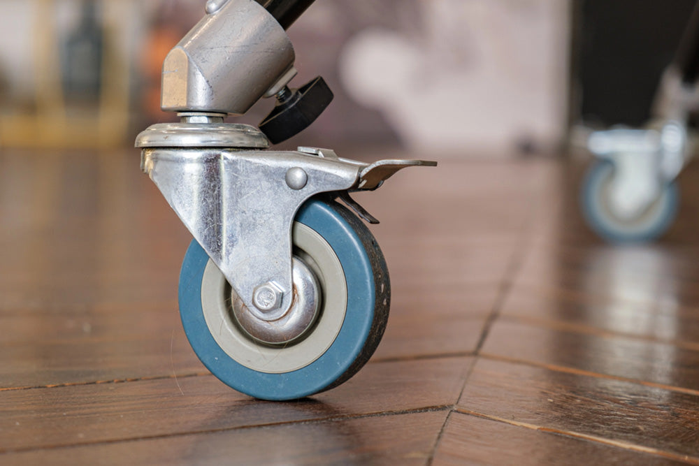Office chair caster wheels rolling on a hard floor