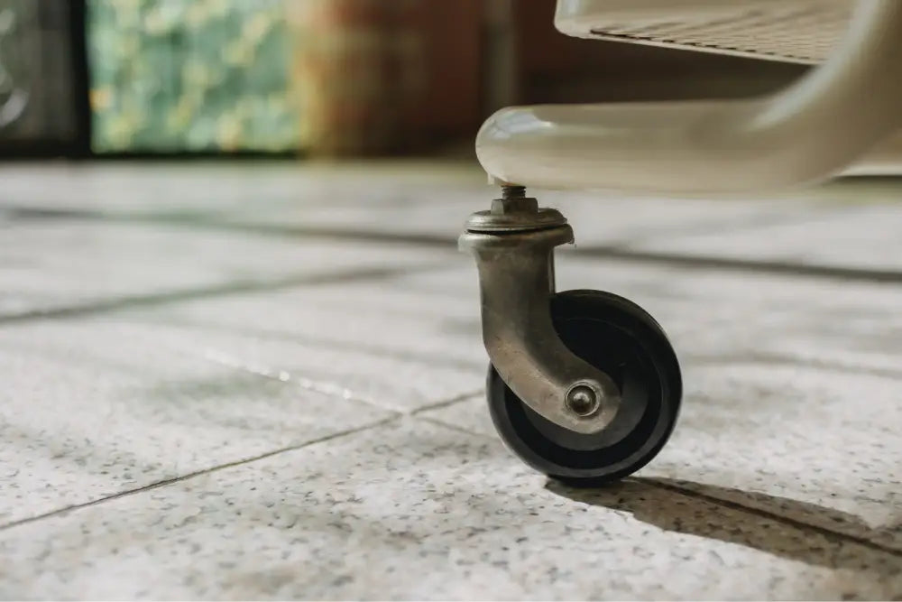 Caster wheel on a portable cabinet resting on a floor