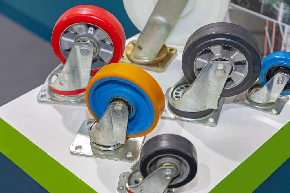 A swivel caster shown next to a plain fixed wheel