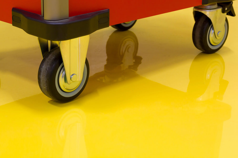Adjustable leveling casters stabilizing industrial equipment